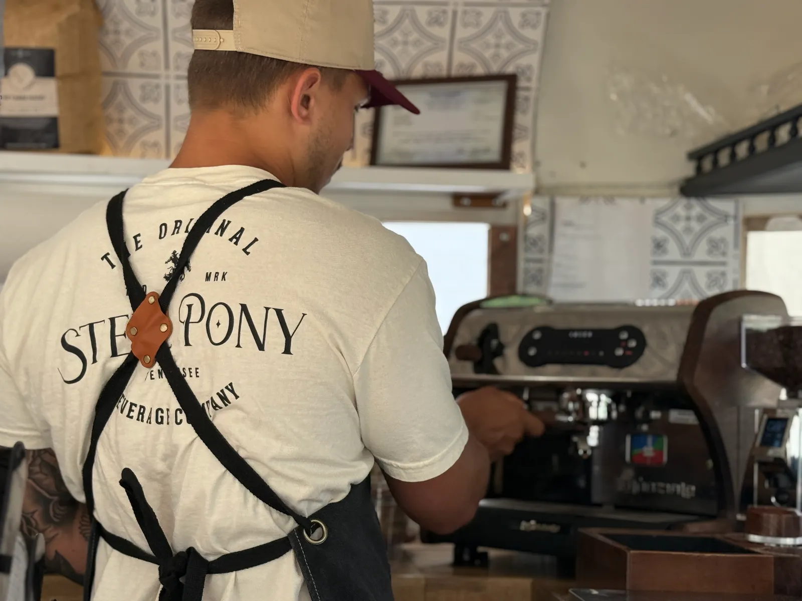 A Steel Pony barista pulling espresso inside the coffee trailer