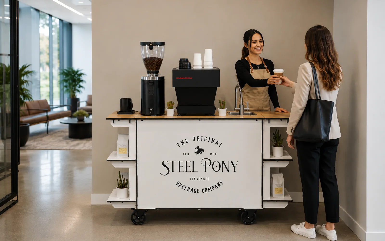 A Steel Pony barista handing a coffee to an employee from the branded office cart in a modern lobby