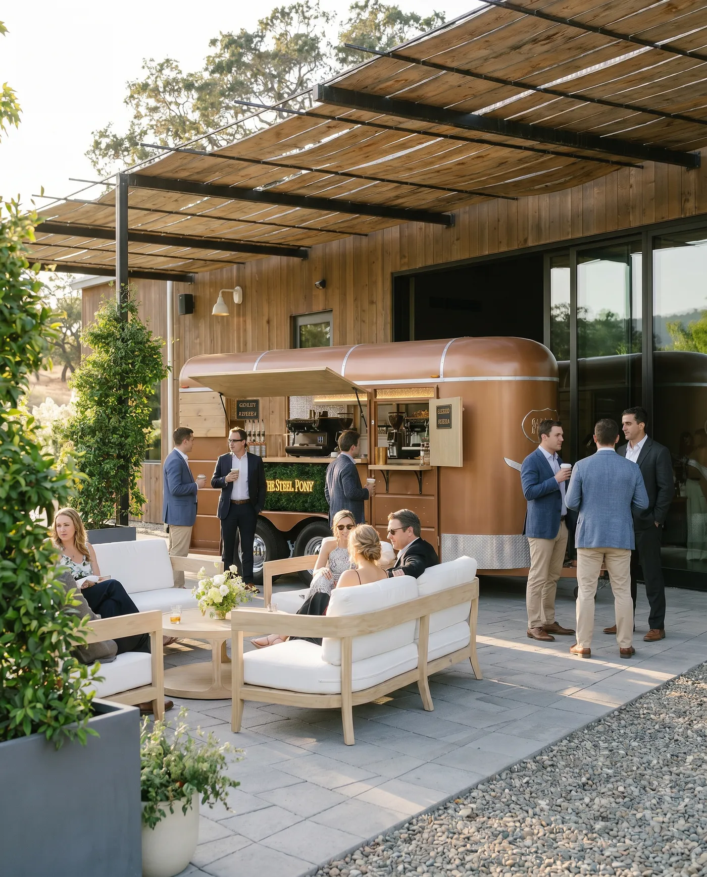 The Steel Pony coffee trailer parked at an upscale property with guests relaxing in an outdoor lounge