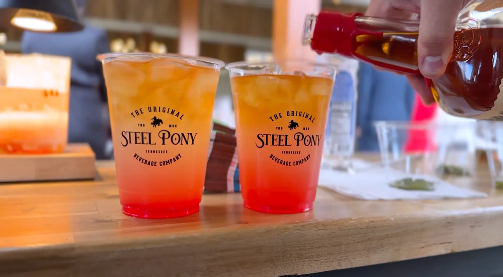 Two branded Steel Pony cups poured with a seasonal cocktail